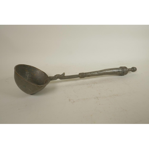 287 - An antique Indian iron betel nut cutter, together with a metal oil ladle, 16