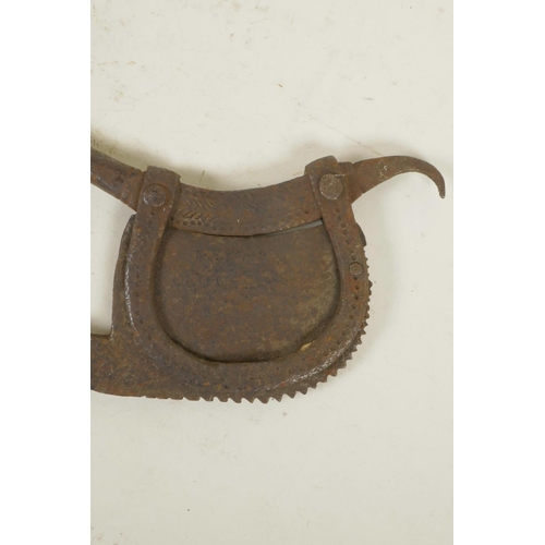 287 - An antique Indian iron betel nut cutter, together with a metal oil ladle, 16