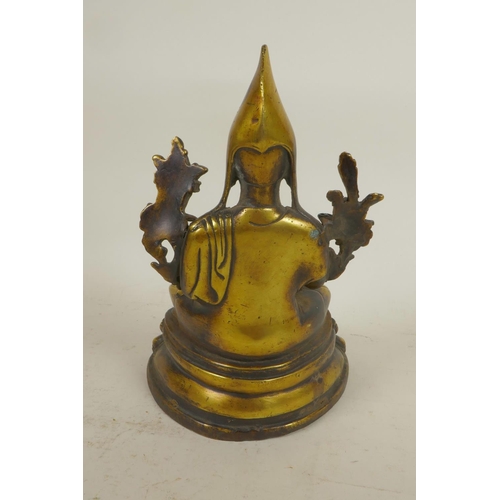 29 - A Sino-Tibetan brass figure of a monk seated in meditation, 9