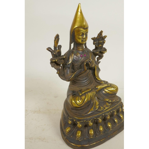 29 - A Sino-Tibetan brass figure of a monk seated in meditation, 9