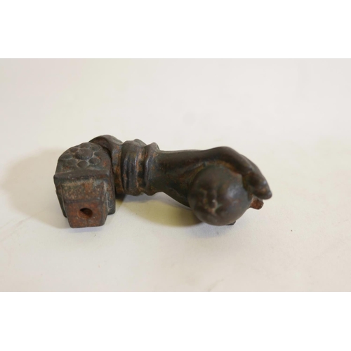 290 - A C19th cast iron door knocker in the form of a hand clutching a fruit