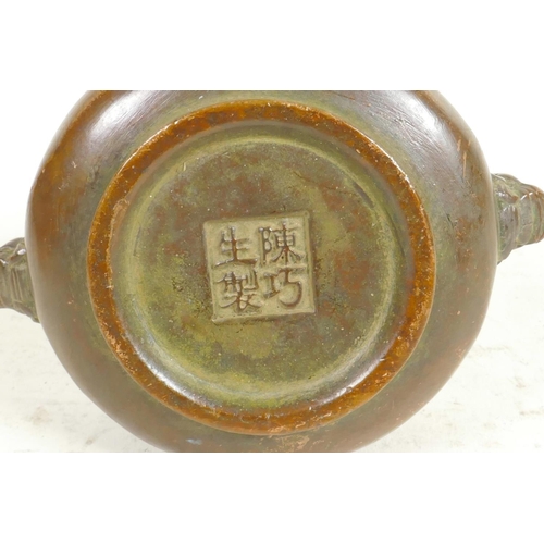 291 - A Chinese miniature bronze censer with cast lion's mask handles, seal mark to base, 3