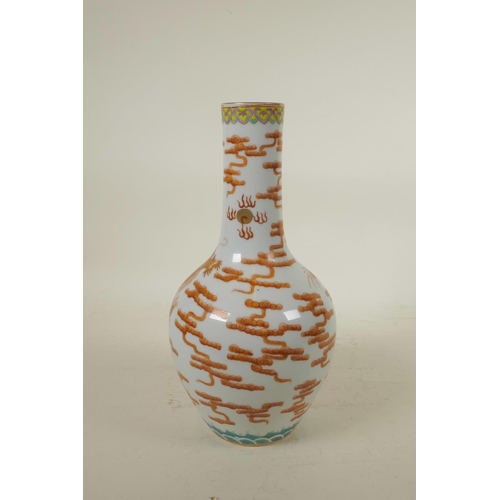 298 - A Chinese polychrome porcelain bottle vase, decorated with an iron red dragon chasing the flaming pe... 