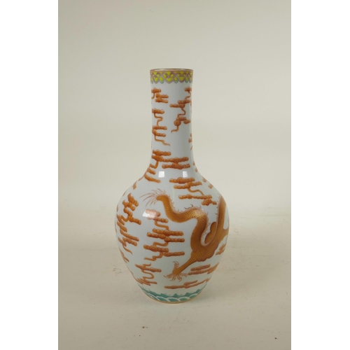 298 - A Chinese polychrome porcelain bottle vase, decorated with an iron red dragon chasing the flaming pe... 