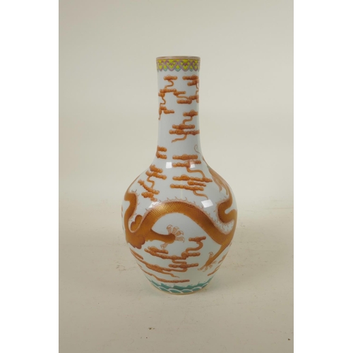 298 - A Chinese polychrome porcelain bottle vase, decorated with an iron red dragon chasing the flaming pe... 