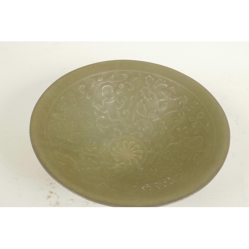 300 - A Chinese celadon porcelain bowl, the interior embossed with figures, 7¼