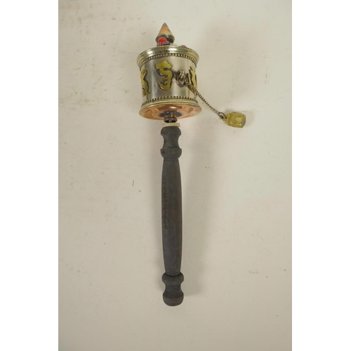 304 - A Tibetan multi metal prayer wheel together with two conch shells, 7