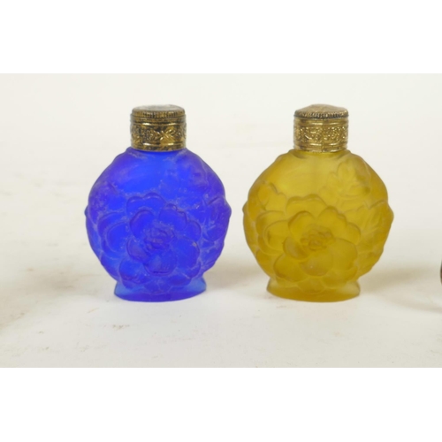 305 - Two miniature carved faux tortoiseshell elephants, together with two coloured glass scent bottles, 2... 