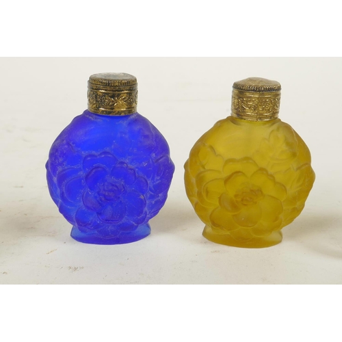 305 - Two miniature carved faux tortoiseshell elephants, together with two coloured glass scent bottles, 2... 