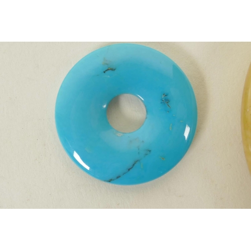 310 - A Chinese turquoise pi-disc pendant, and another larger composition pi disc, largest 2½