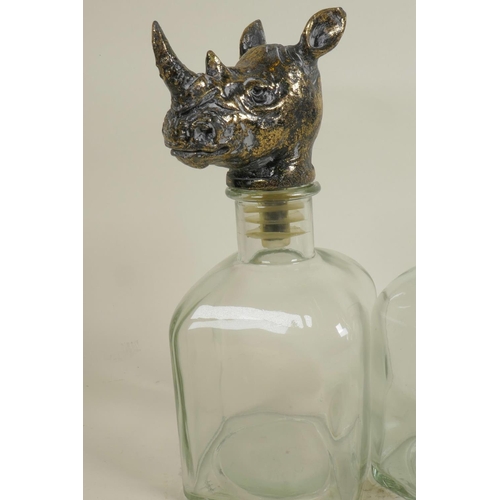 314 - A pair of square section glass decanters with animal head stoppers, 10