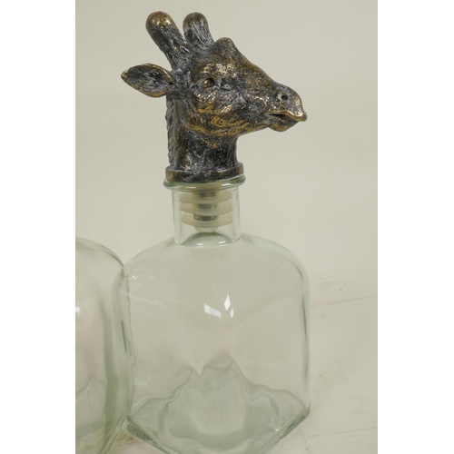 314 - A pair of square section glass decanters with animal head stoppers, 10