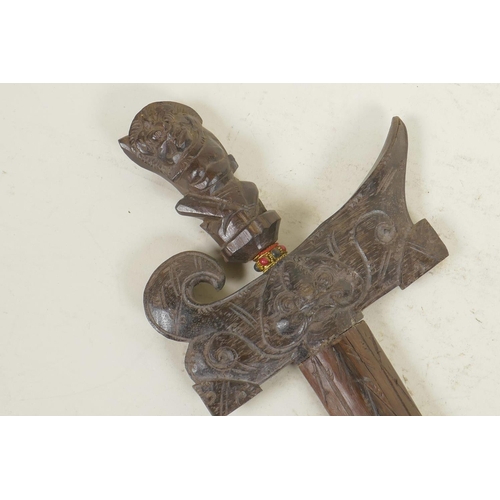 319 - An Indonesian kris with a traditional carved hardwood sheath and handle, 16½