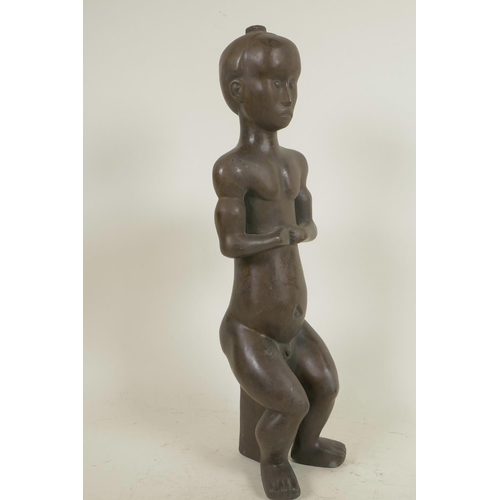 324 - An African bronze figure of a seated man, 14½