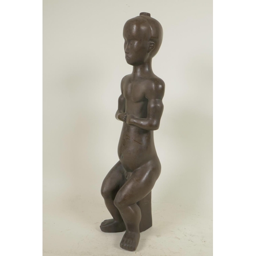 324 - An African bronze figure of a seated man, 14½