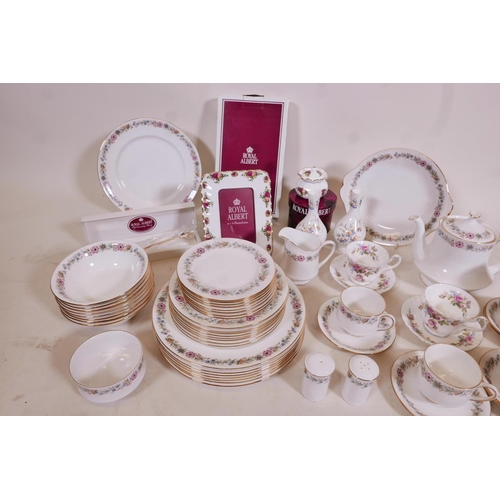 329 - A large quantity of Royal Albert bone china including an 'Old Country Roses' photo frame, 8