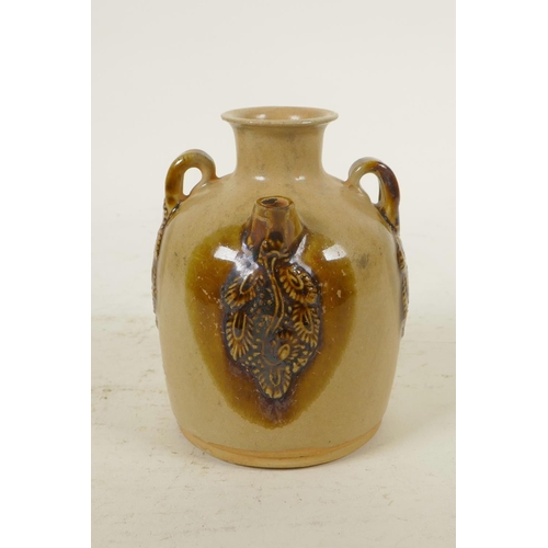 333 - A Chinese ochre ground wine pourer with glazed, raised vine decoration, 4½