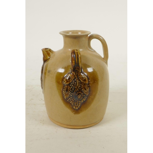 333 - A Chinese ochre ground wine pourer with glazed, raised vine decoration, 4½