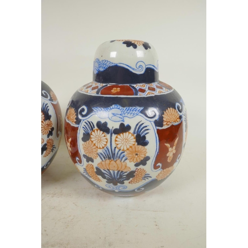 337 - A pair of pottery lamp bases in the form of lidded ginger jars decorated in the Imari palette, 8¼