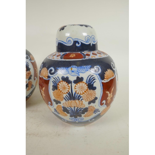 337 - A pair of pottery lamp bases in the form of lidded ginger jars decorated in the Imari palette, 8¼