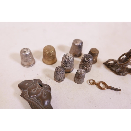 339 - A quantity of hallmarked silver and other thimbles, and brass key and eastern bronze stamp