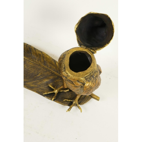 341 - A bronze pen tray and inkwell cast as an owl standing on a large feather, 13½