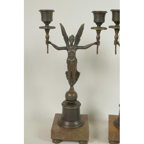 349 - A pair of bronze two branch candelabra, the  torch pattern sconces supported by angels, 13