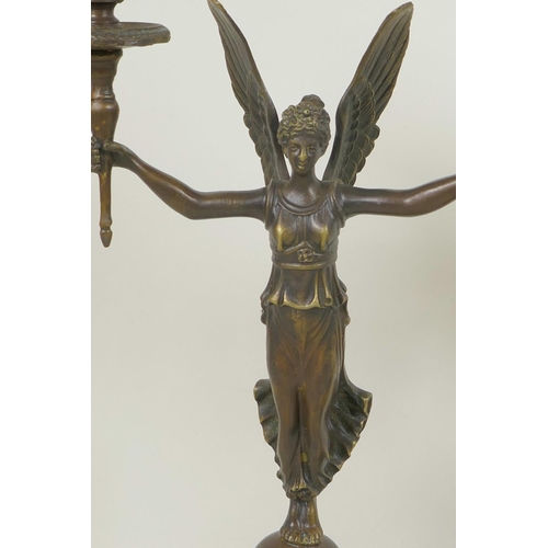 349 - A pair of bronze two branch candelabra, the  torch pattern sconces supported by angels, 13