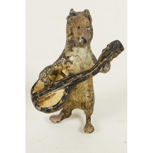 352 - A miniature cold painted bronze figurine of a dog playing a banjo, 1¾