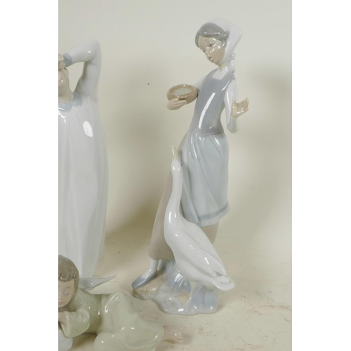 353 - Three Lladro porcelain figurines, girl feeding geese, waking child and a sleeping angel, tallest 9½