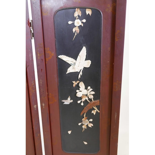 36 - A Japanese lacquer four panel screen with inset bone, mother of pearl and wood decoration depicting ... 