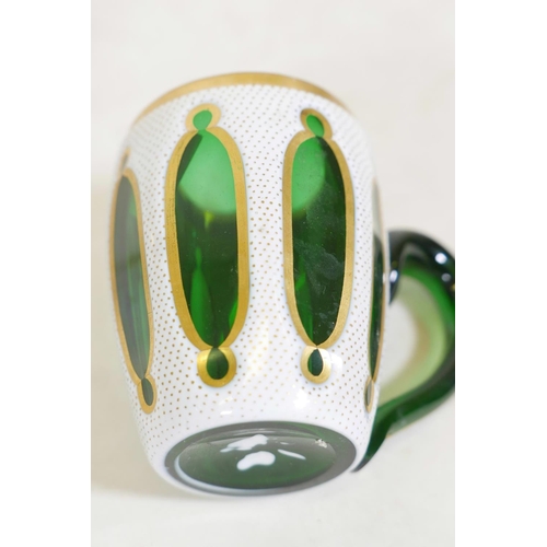 361 - A pair of Bohemian overlaid and gilt glass mugs, 3½