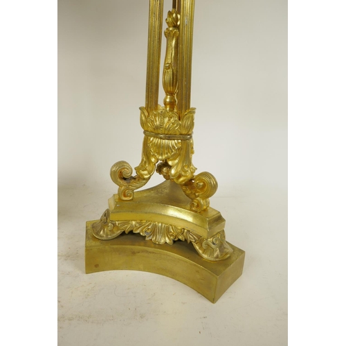 386 - A pair of ornate ormolu four branch candlesticks with triple reeded columns and triform base, all wi... 