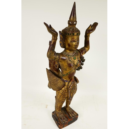 399 - A Thai, carved wood, painted, bejewelled and mirrored figure of a kinnara, 20