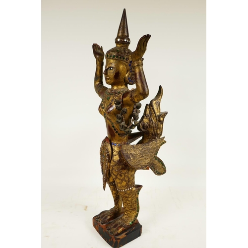 399 - A Thai, carved wood, painted, bejewelled and mirrored figure of a kinnara, 20