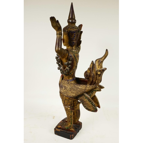 399 - A Thai, carved wood, painted, bejewelled and mirrored figure of a kinnara, 20