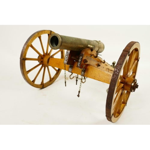 400 - An antique ornamental table top bronze cannon, on a hand made wooden carriage with metal fittings, 1... 