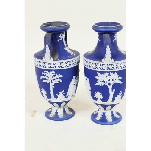 409 - A pair of C19th Wedgwood Jasperware two handled pedestal vases decorated with Grecian figures, 6