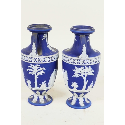 409 - A pair of C19th Wedgwood Jasperware two handled pedestal vases decorated with Grecian figures, 6