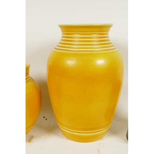 418 - A yellow glazed Bretby Pottery baluster vase with ring turned neck, 8¾