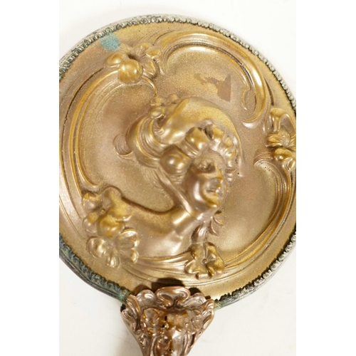 419 - A C19th Art Nouveau bronze hand mirror embossed with scrolls and faces, and bejewelled glass mirror,... 