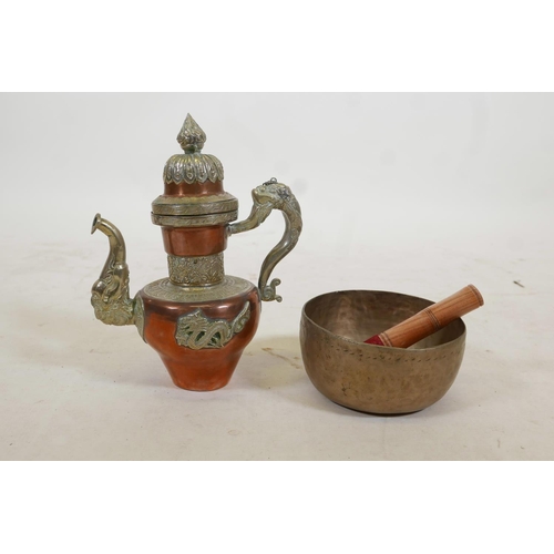 42 - A Tibetan brass singing bowl, and an Oriental copper and white metal kettle with dragon and kylin de... 