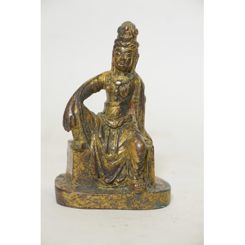 421 - A bronze figure of a seated Buddhistic figure, with worn gilt patination, 5