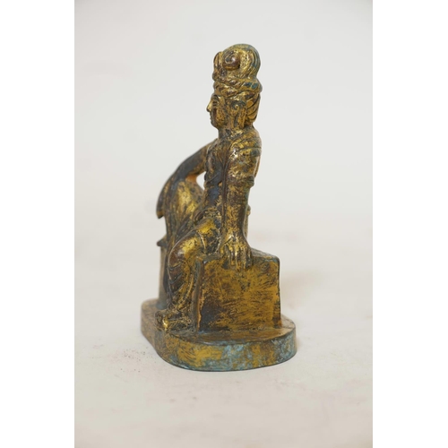 421 - A bronze figure of a seated Buddhistic figure, with worn gilt patination, 5