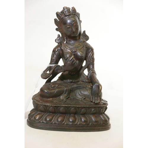 428 - A Bronze Buddhistic figure, seated upon a lotus throne, with distressed gilt decoration, 7