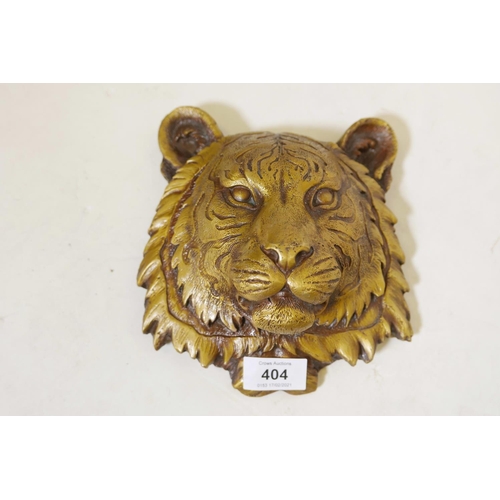 432 - A patinated brass wall plaque in the form of a tiger's mask, 7½