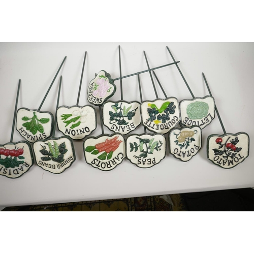 44 - A set of twelve painted cast iron vegetable and herb markers, 14