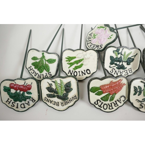 44 - A set of twelve painted cast iron vegetable and herb markers, 14