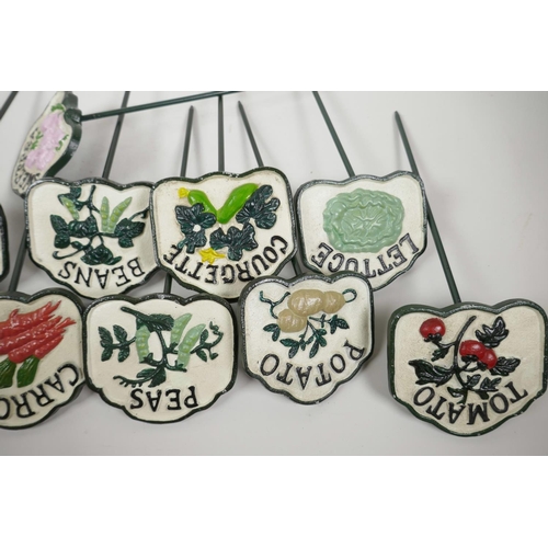 44 - A set of twelve painted cast iron vegetable and herb markers, 14