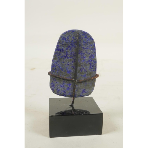 466 - A Chinese carved lapis lazuli pendant decorated with Buddha, in a display mount